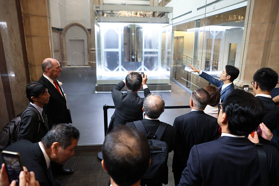 A crow of people look at a quantum computer