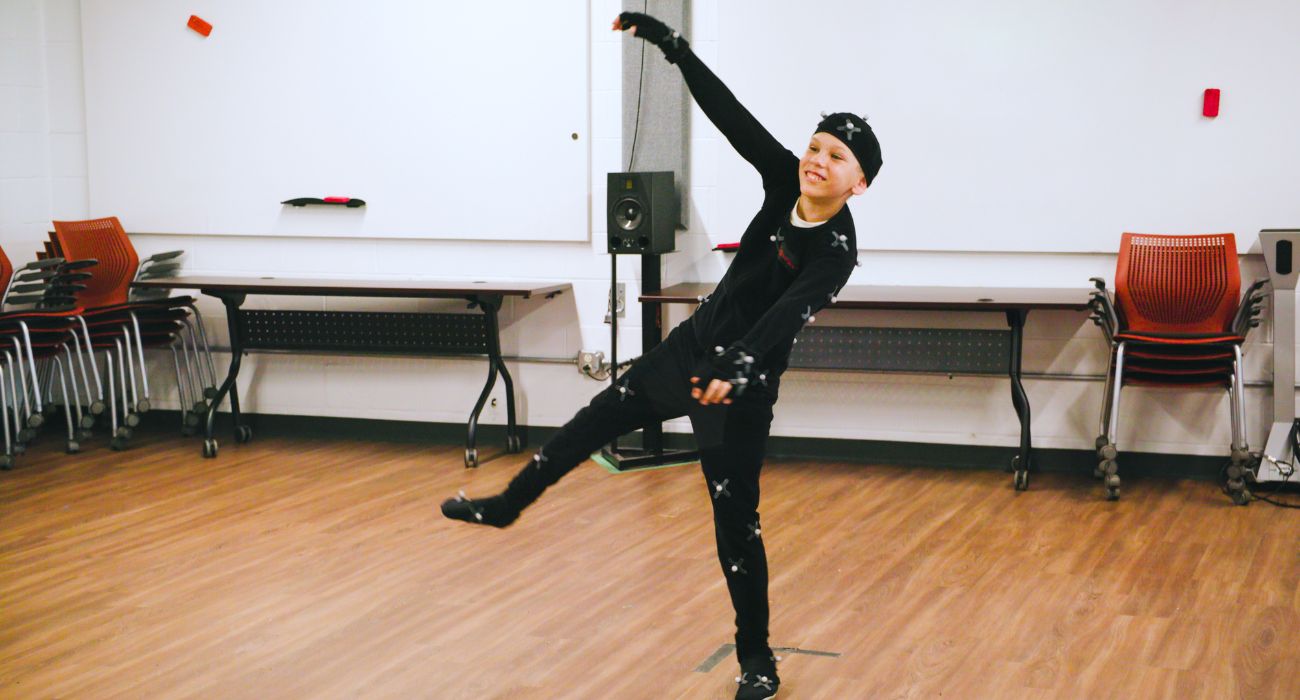 A person in a motion capture suit performs a kick