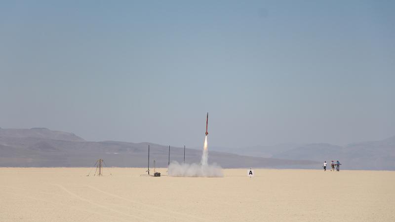 Small rocket shooting into the sky