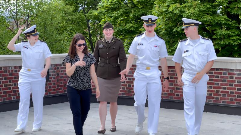 Candid of 4 ROTC soldiers in uniform and one civilian laughing and walking outside