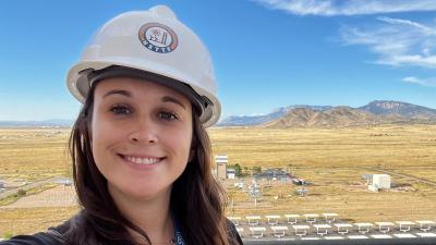 Emily de Stefanis wearing hardhat with desert in the background