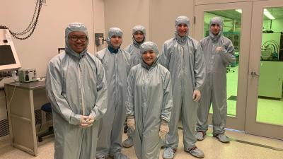 College students wearing clean room suits