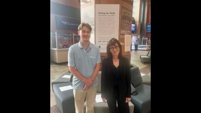 Joey Morse '24 and Sara Tack, senior lecturer in the School of Humanities, Arts, and Social Sciences’ Communications and Media program stand in front of the exhibit