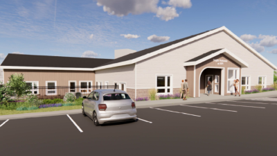 External rendering of daycare center; a single-story white and brown building labeled "Bright Horizons at RPI"